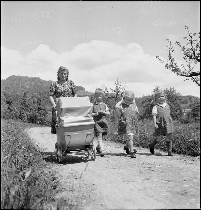 Mother and children walking, 1941.