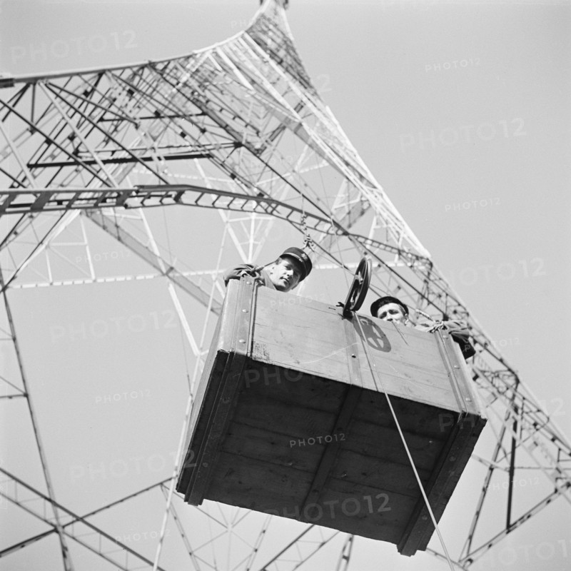 Policeman and technician in lift at radio tower of Radio Beromuenster.