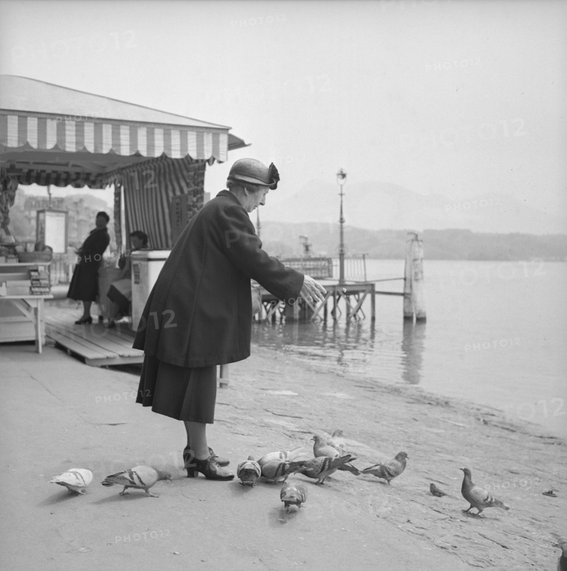 Woman feeding pidgeons in Lucerne, 1954.