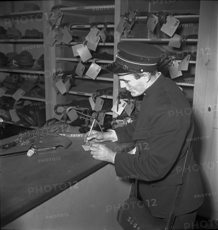 Conductor in lost property office, Oensingen 1949.