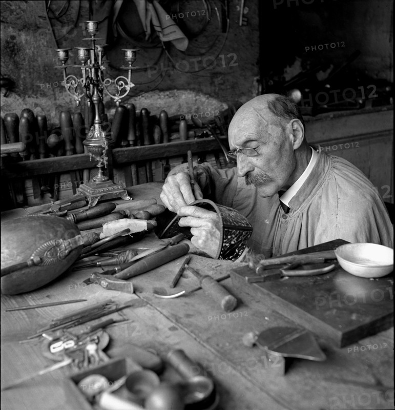 Geneva: artist blacksmith in his studio; 1943.