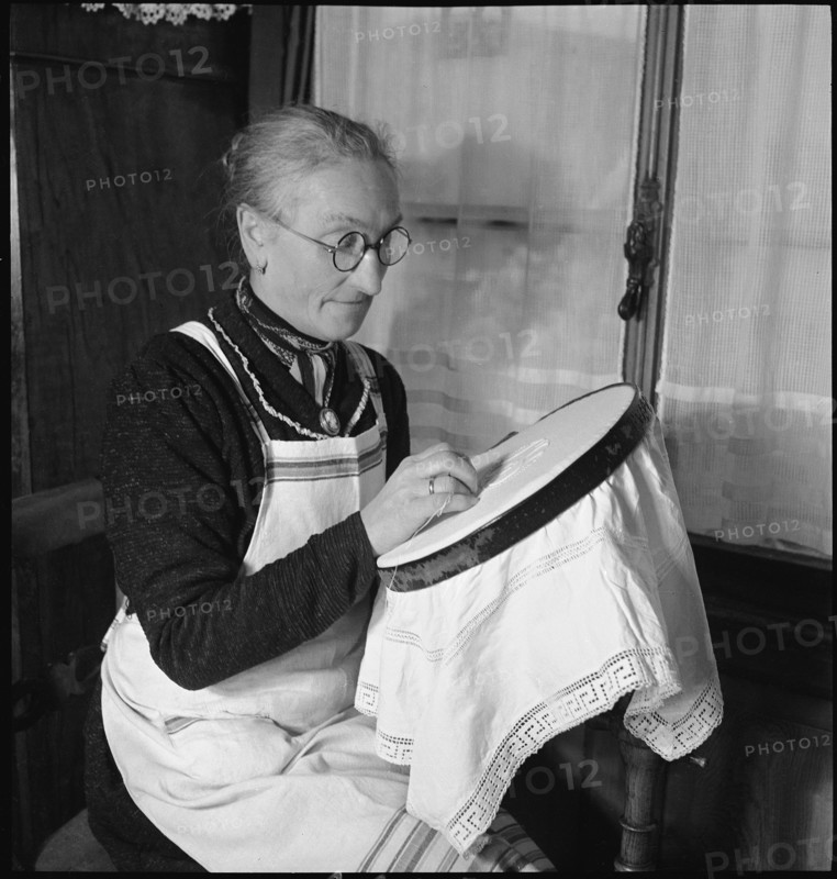 Home embroideress at work, 1942.