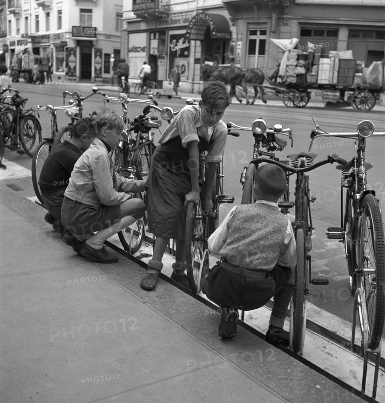 Basle, boys cleaning bicycles; 1941.