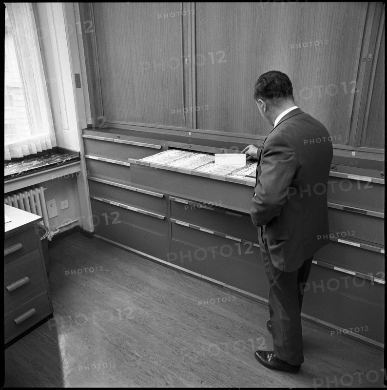 Policeman of the Zurich metropolitan police at the register of prostitutes 1969.