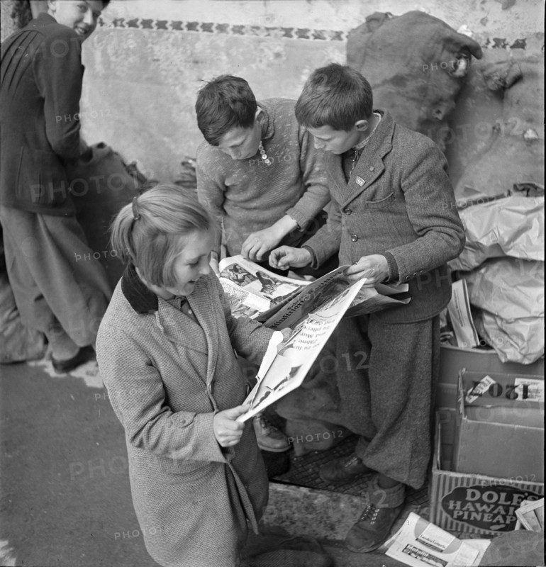 W K 2: war economics; young people collecting material to be recycled.