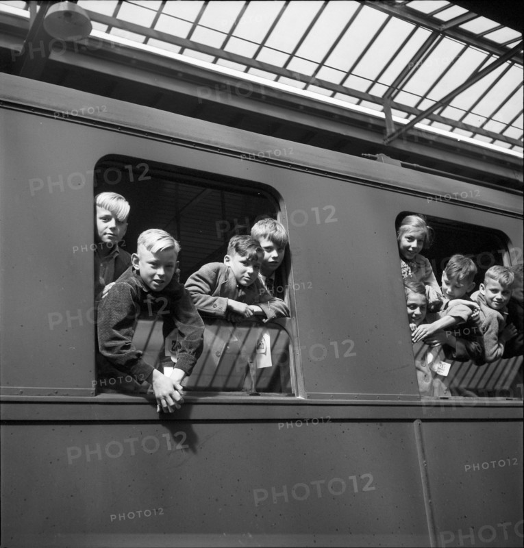 Children looking out of the train window.