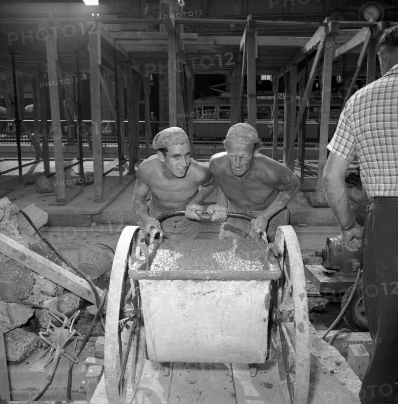 Workers at building site; 1953.