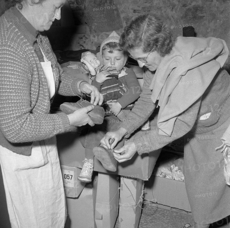 Hungarian women clothing a child, Uerikon 1956.