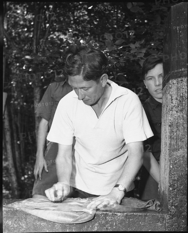 English boy scout doing laundry, 1950.