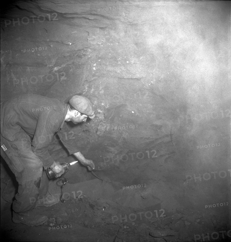 Herznach mine, miner prepares for blasting; 1952.