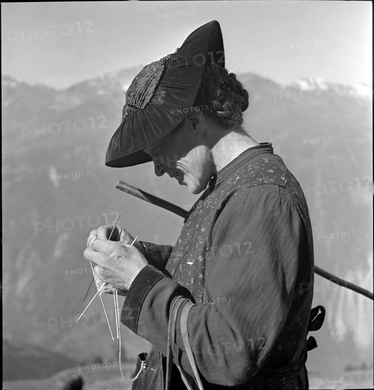 Woman knitting on the Alpine pasture, Valais 1942.