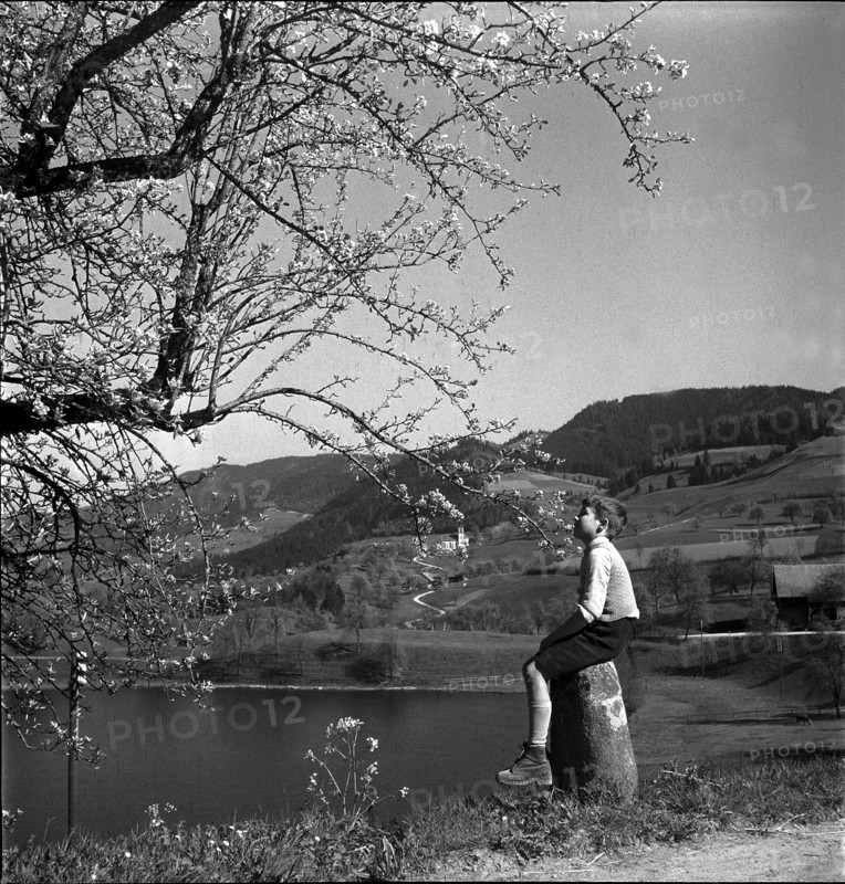 Boy sitting at the Finstersee lake shore, 1946.