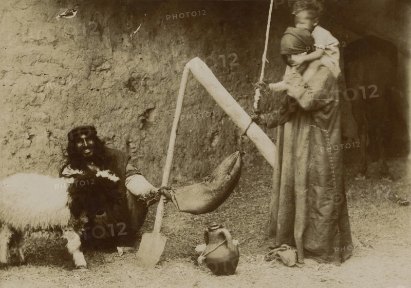 Arabs making butter. 
	
		1920-1940
