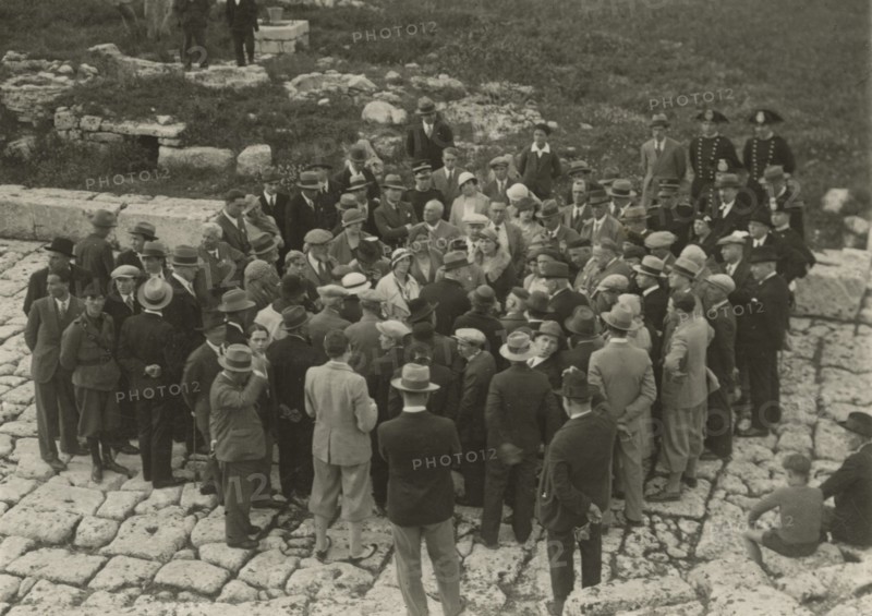 A small group around a guide. 
	
		1924