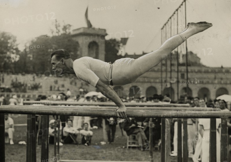 Athlete on the parallel bars at the Arena Civica in Milan.