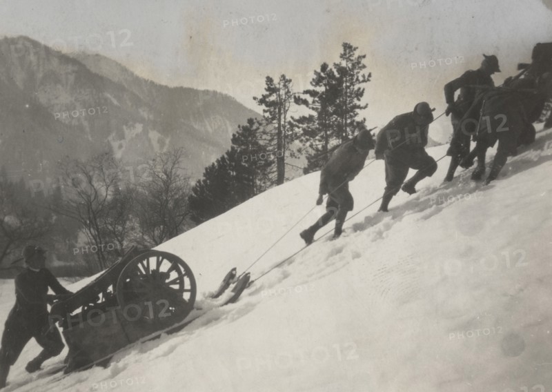 Soldiers tow a piece of heavy artillery through the snow