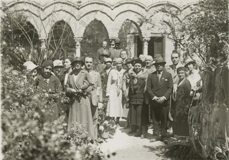 Members of the Touring Club Italiano visiting the cloister of Monreale Cathedral. 
	
		1924