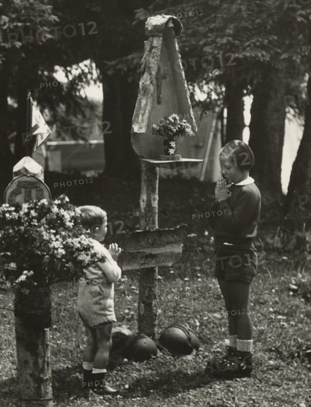 Touring Club campsite at the Pale di San Martino: two children at the camp altar. 1951