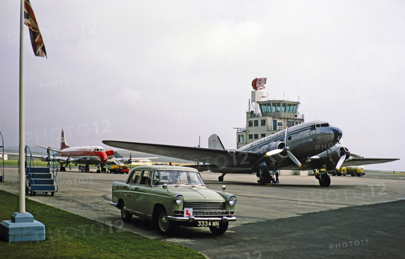 Morris Oxford car, Douglas DC3 plane of Strathair Airways, Vickers Viscount 701 plane of Cambrian Airways, Ronaldsway airport, Isle of Man, c 1965.