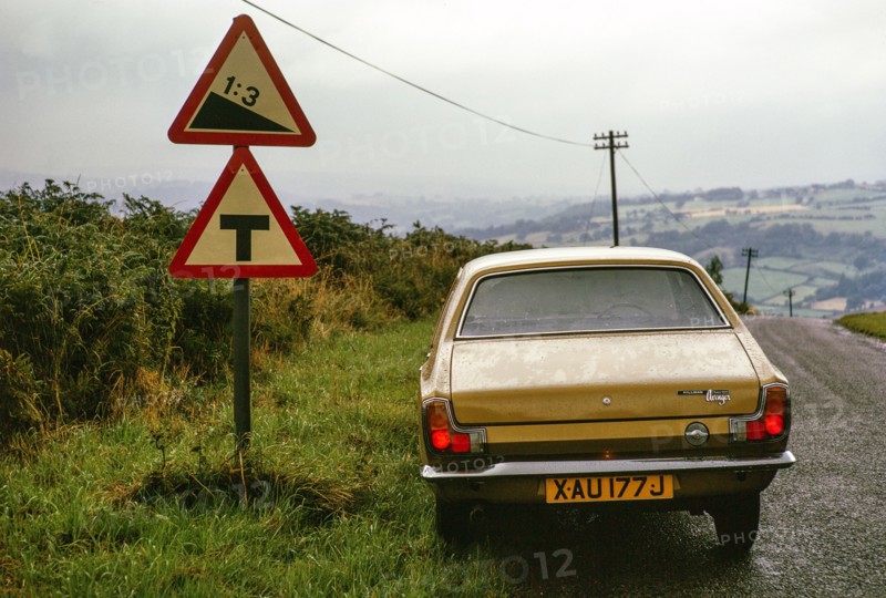 1 in 3 gradient road sign, near Grosmont, north Yorkshire, England, UK 1 September 1974 Hillman Avenger car.