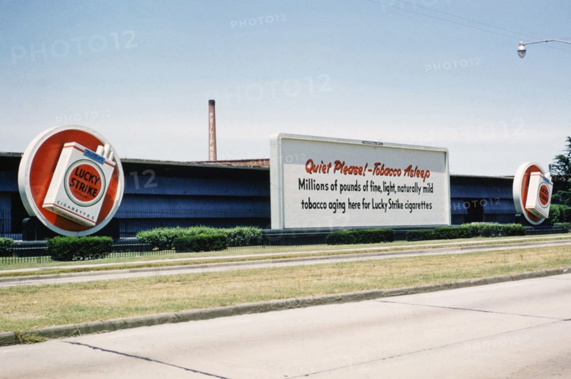 Lucky Strike cigarette advert, Philip Morris tobacco factory, thought to be Durham, North Carolina. USA c 1953.