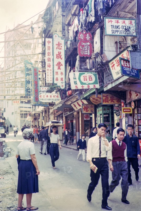 Captioned as 'Chinese flower stalls', Victoria, Hong Kong, Asia 1964 - note bamboo scaffolding.