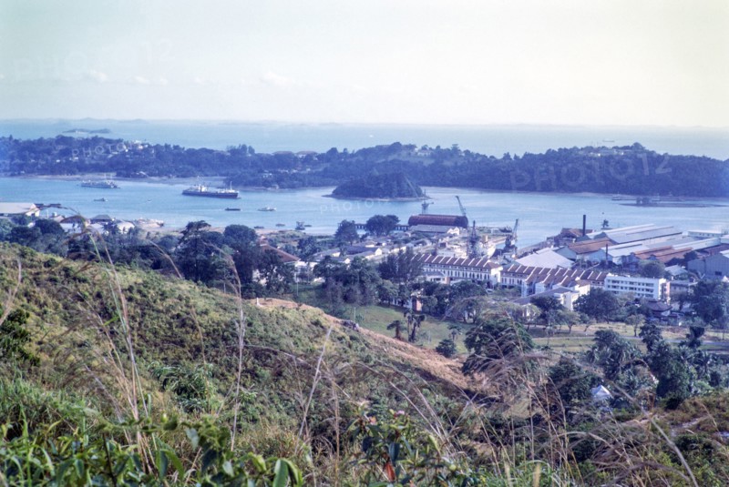 View to port docks of Keppel Harbour from Mount Faber, Singapore, southeast Asia, 1965 - Sentosa Island beyond.
