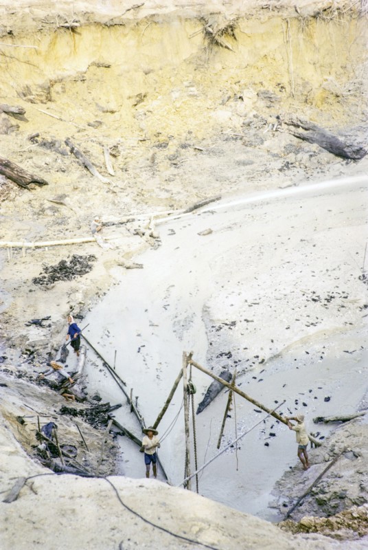 Open Cast gravel-pumping tin mine Malaya, Malaysia, south east Asia 1964 -  high pressure water cannon jet spray to wash out sediment into a slurry.