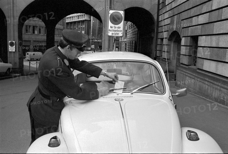 Policeman distributes monetary fines, Zurich 1970