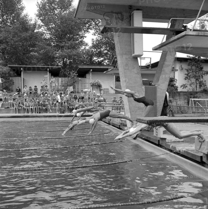 Zurich, gilrs taking a header during swimming lesson in a open air bath 1956