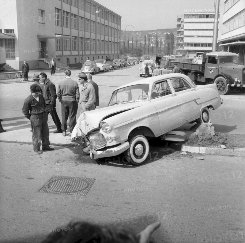 Workers watching a damaged car 1959