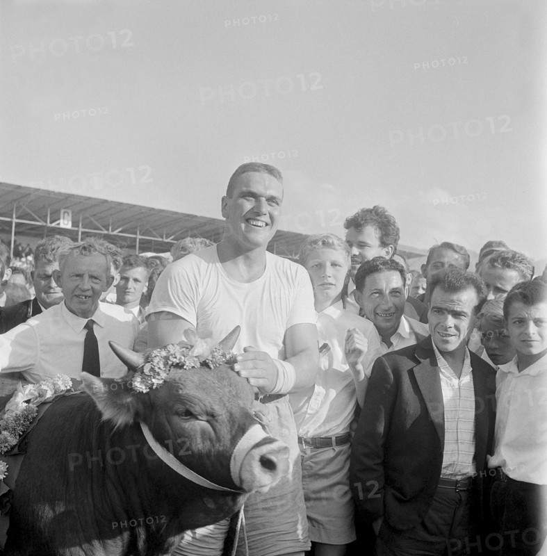 Swiss wrestling festival Zug 1961: champion Meli with bull