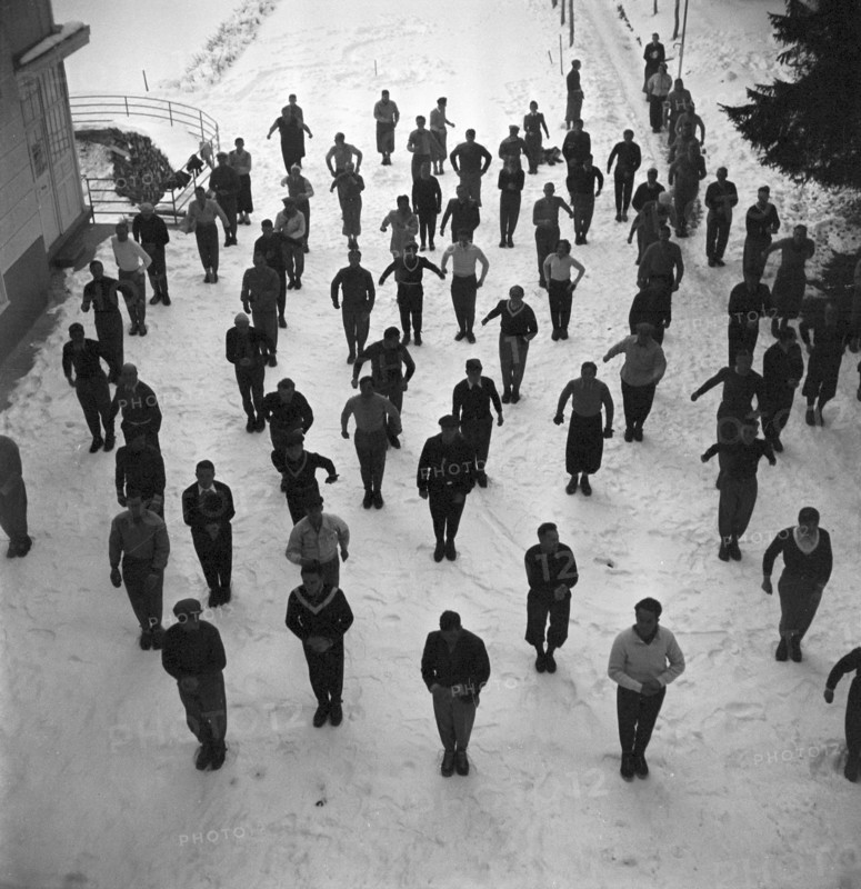 Ski instructors doing gymnastics before skiing, Davos 1940