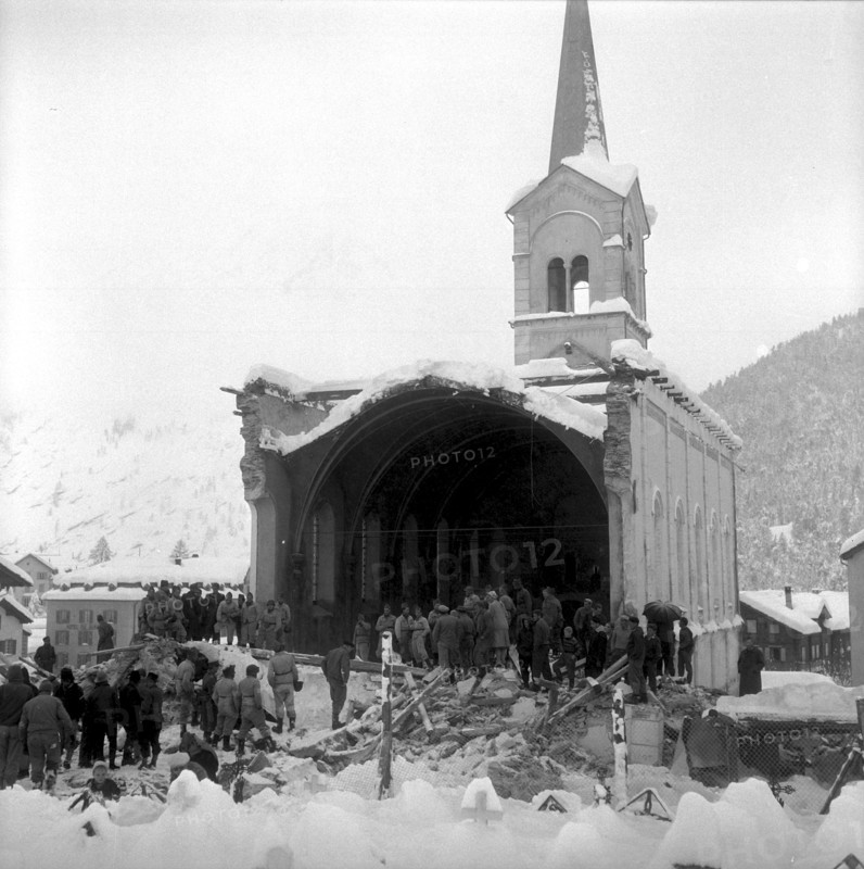 Dilapidated church blasting in Saas Fee, onlookers watching the demolished nave 1959