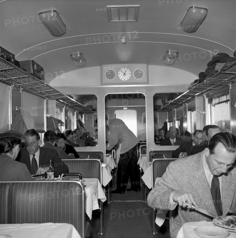 Waiter serving customers in a dining car 1951