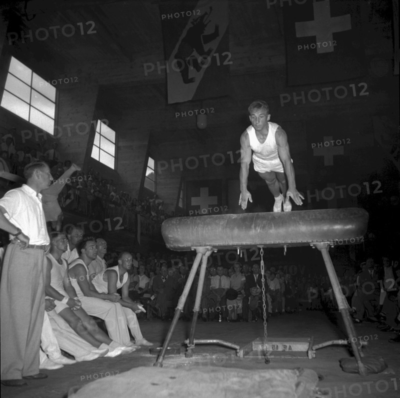Swiss gymnastics day Burgdorf 1953: gymnast doing a horse jump