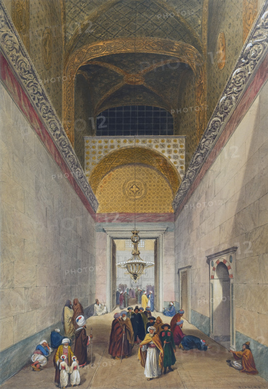 Main entrance to the Ayasofya Mosque with groups of men in traditional dress.