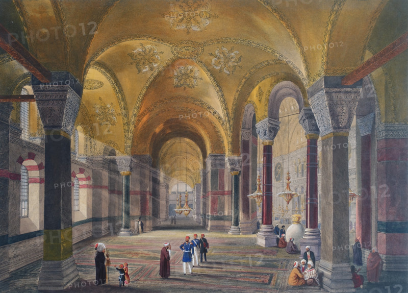 General view of the large nave looking west of Ayasofya Mosque with groups of men in traditional dress.