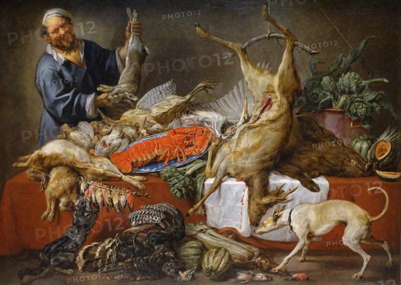 The cook is at the table with wildfowl.
