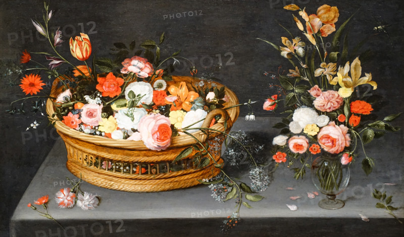 Basket of flowers and a bouquet in a vase.