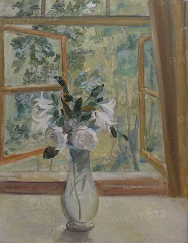 White roses and lilies in front of the window.