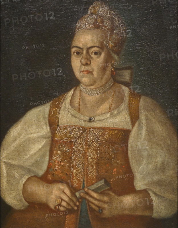 An unknown Arkhangelsk merchant's wife in a brown sleeveless jacket.