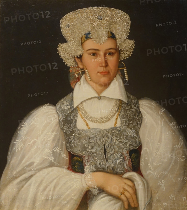 An unknown merchant's wife in a festive costume of the Novgorod province.