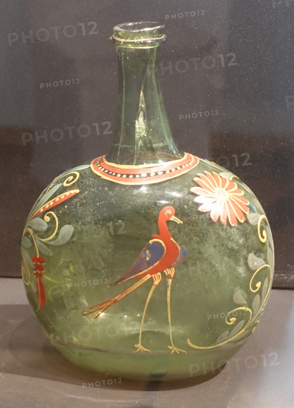 Green bottle with stork and flowers.