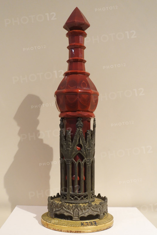 Cologne bottle on stand.