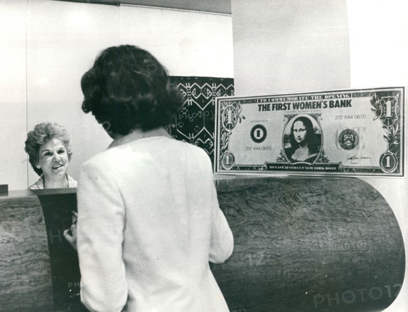 A teller takes care of a customer at the Women's Bank of the State of New York