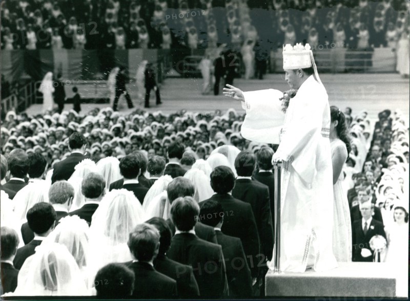 Reverand Sun Yung Moon presides over a mass wedding ceremony for the Unification Church at Madison Square Garden
