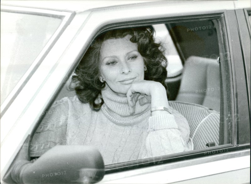 Sophia Loren stares out from inside a car