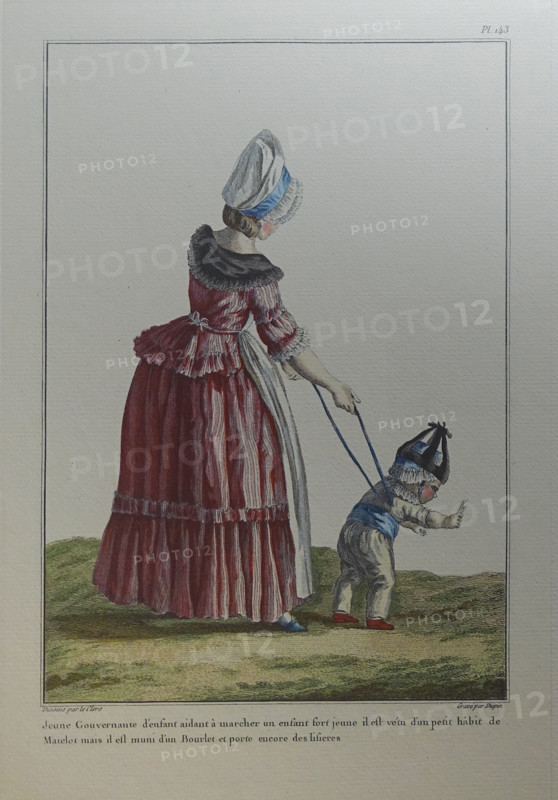Governess and a child in a white suit