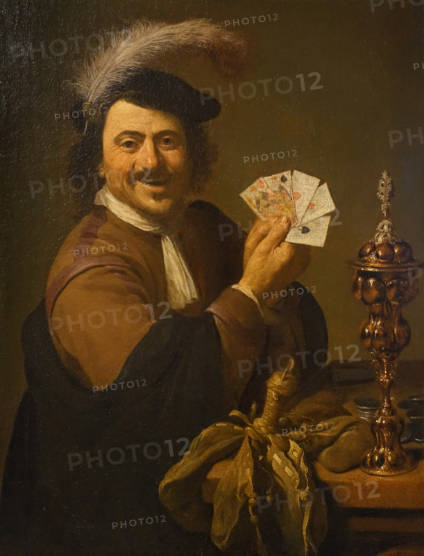 Player with a deck of cards and a cup
